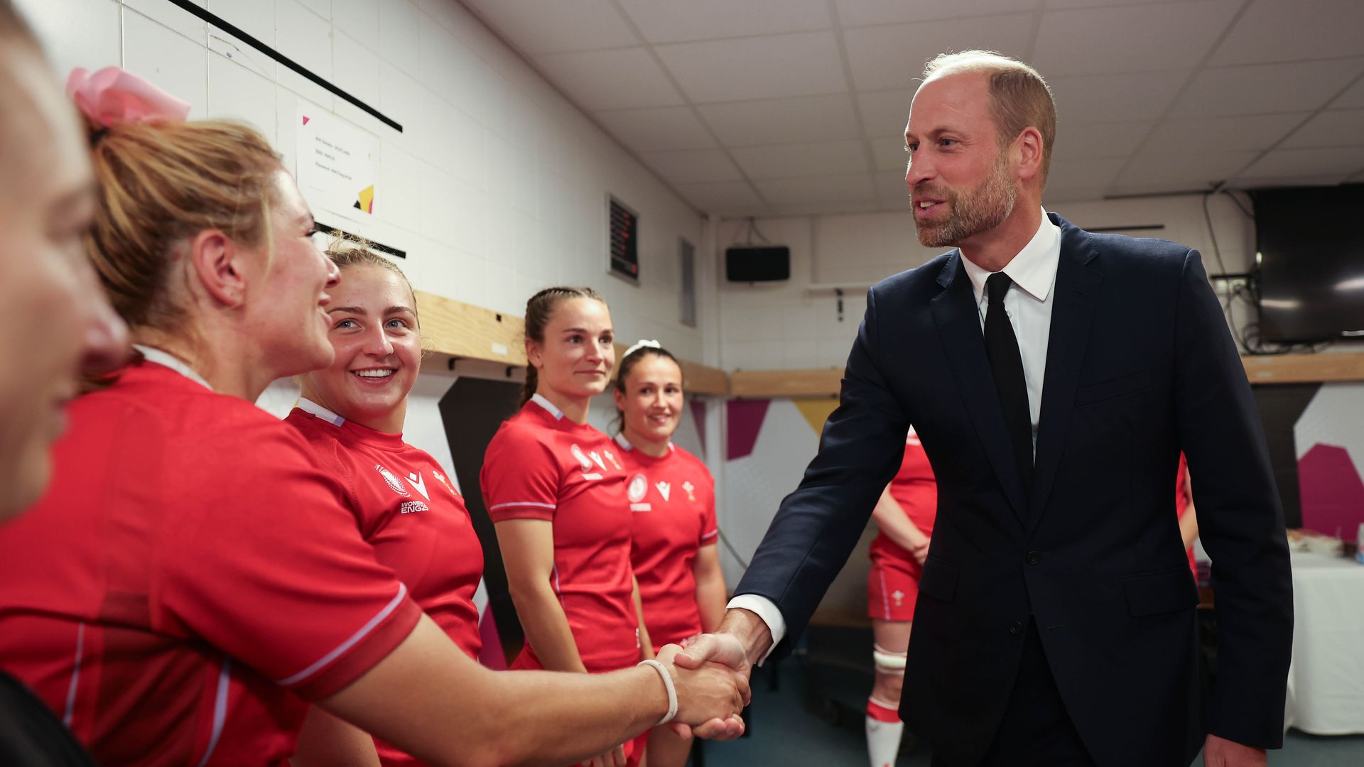 Prince William shaking hands with members of the Welsh women's rugby team