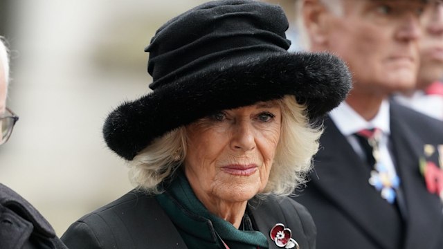 Queen Camilla in a fur hat and black cape