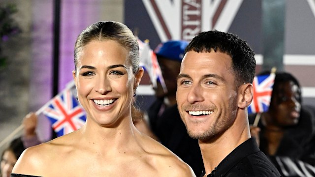 couple in black outfits on red carpet