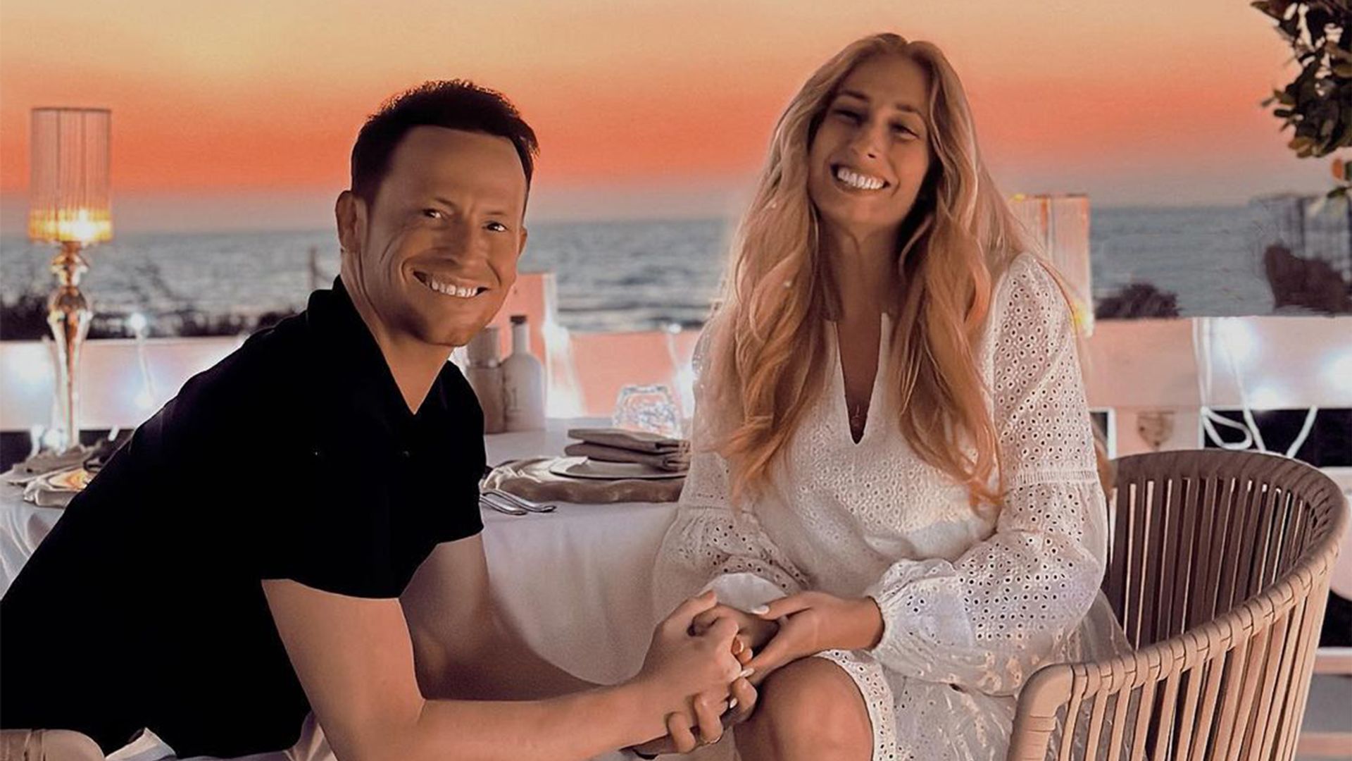 Stacey Solomon and Joe Swash hold hands as they have a romantic dinner