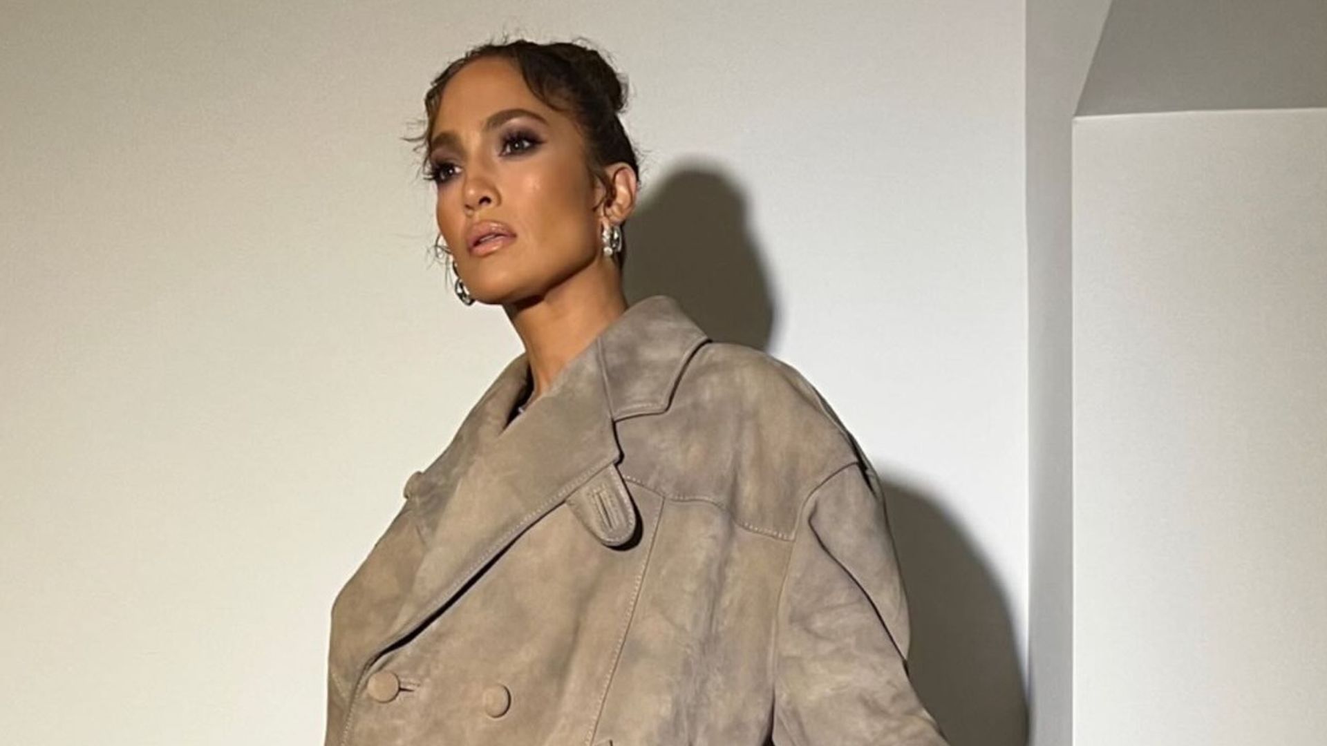 Jennifer Lopez wore a double breasted jacket and calf boots