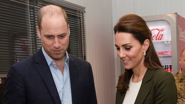 Prince William with Kate Middleton as she slices into a cake