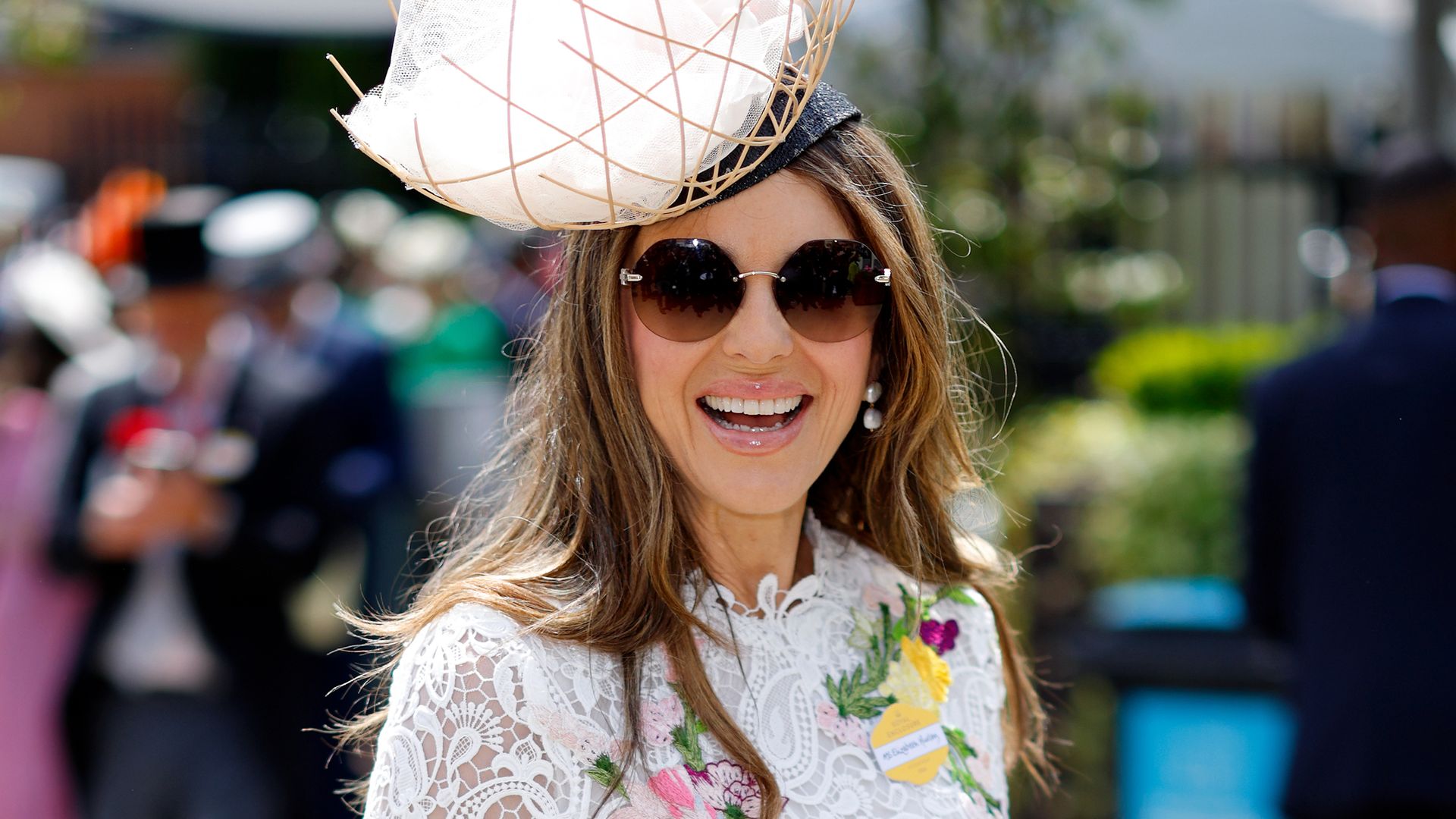 Elizabeth Hurley steps out in figure-hugging lace dress and daring fascinator for exciting day out