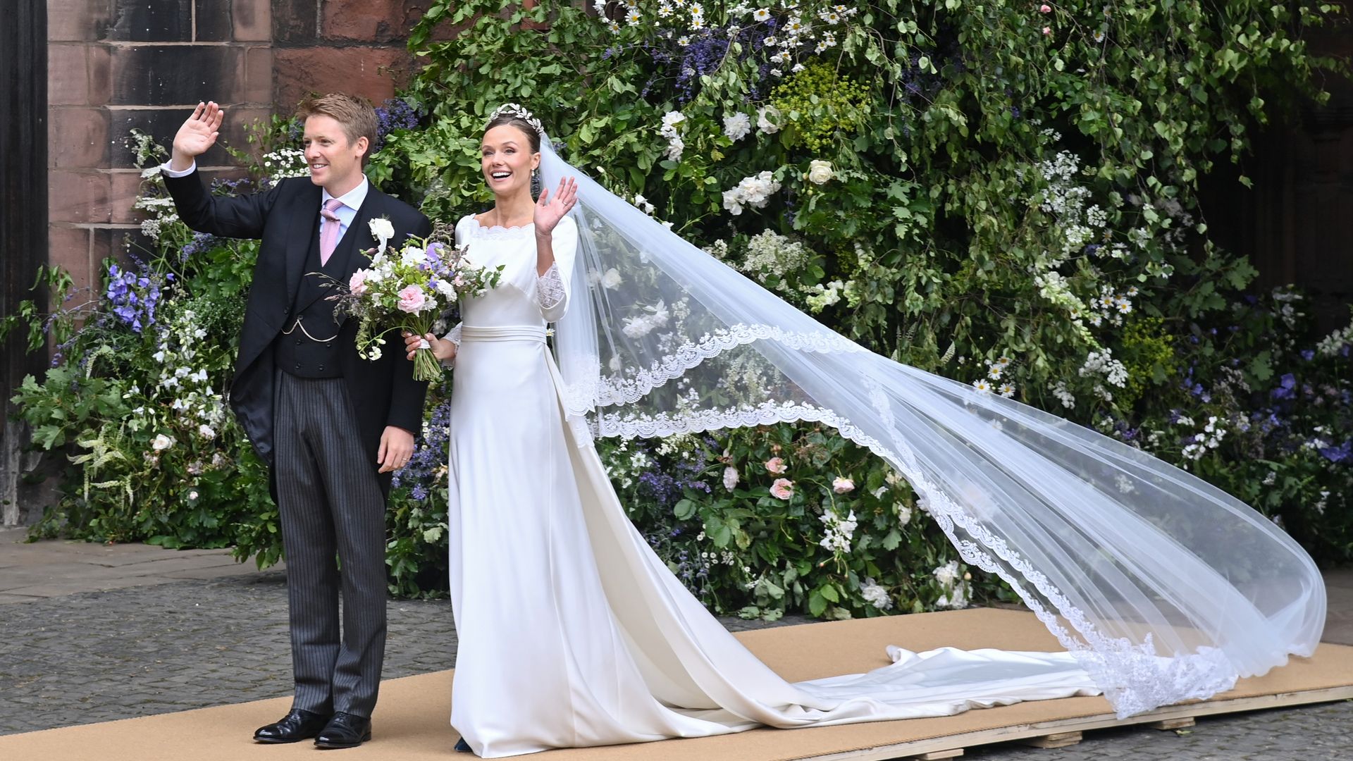 The couple waved to the big crowds after tying the knot