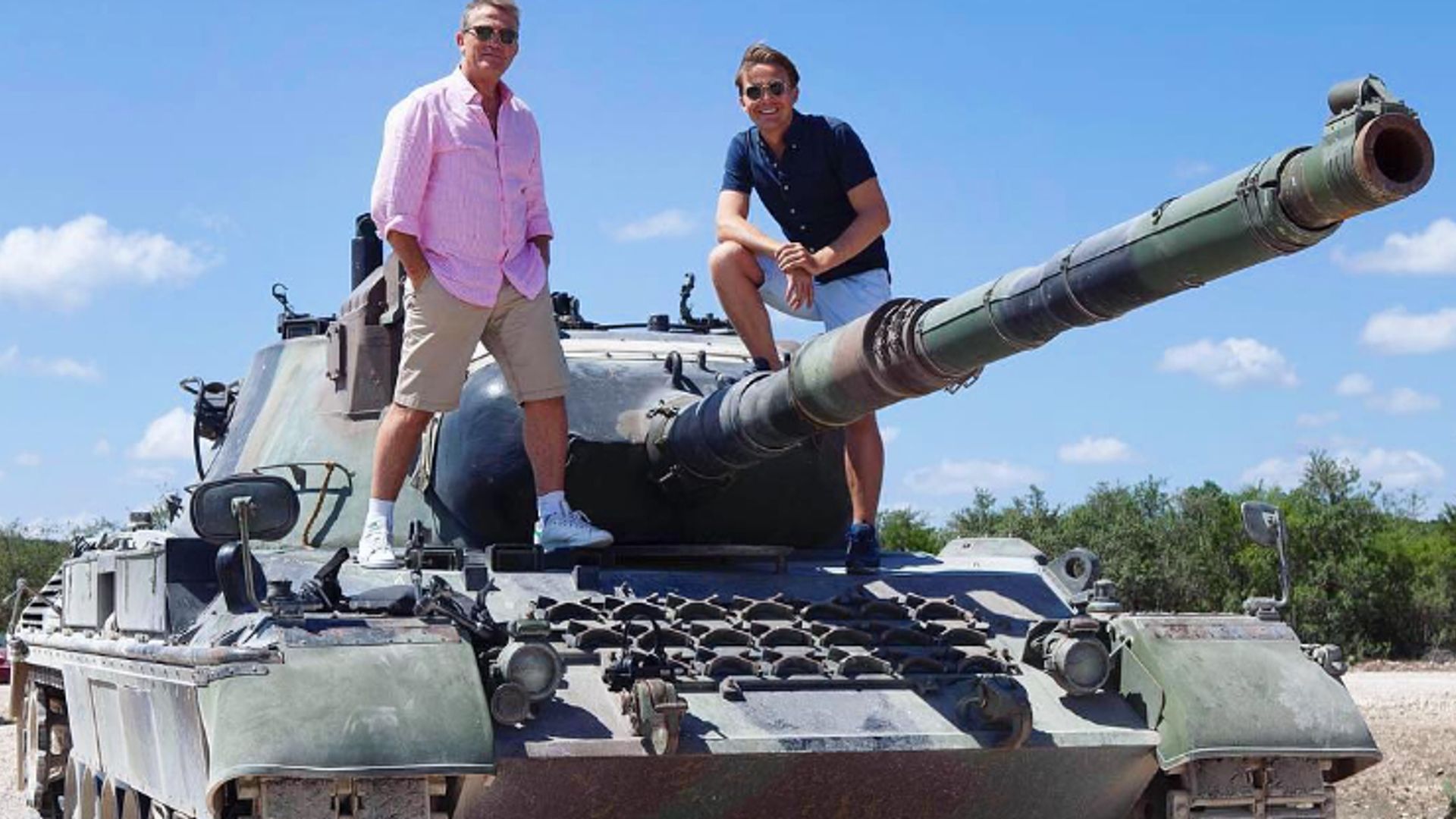 Bradley Walsh and Barney Walsh standing on a tank