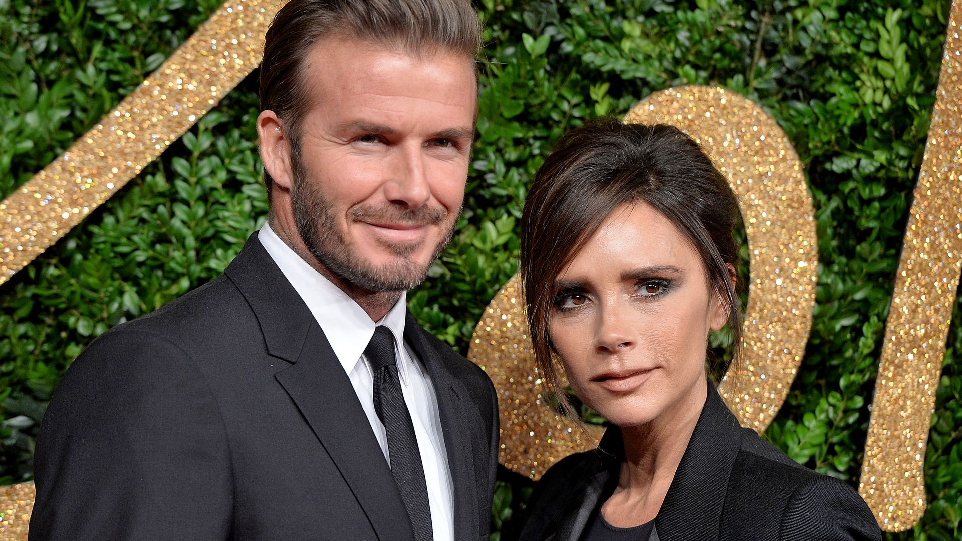 David Beckham and Victoria Beckham at an awards ceremony in all black