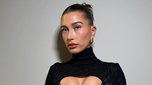 Hailey Bieber poses for a photo in a black cutout dress