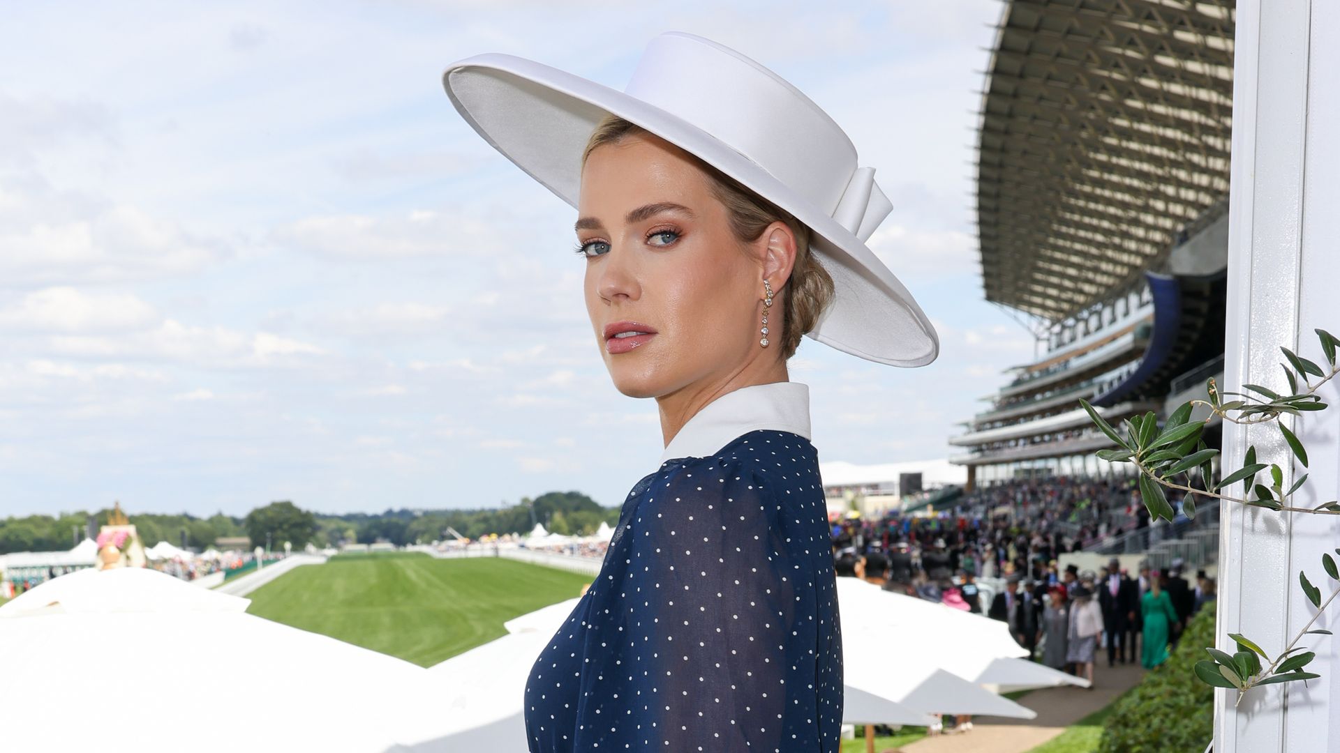 Lady Amelia Spencer in navy polka dot dress and white hat
