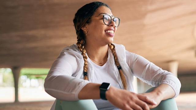 Shot of a sporty young woman taking a break while exercising outdoors