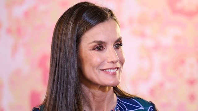 Queen Letizia smiling in floral dress 