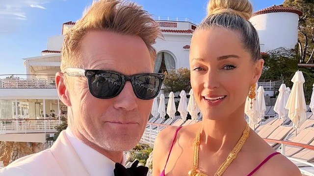 Ronan Keating in a white suit with Storm Keating in a pink dress
