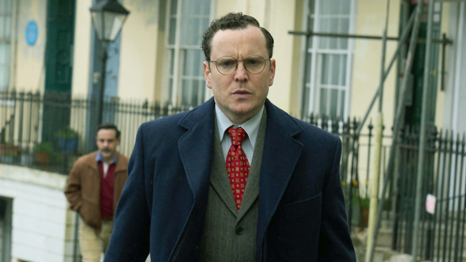 man in suit walking down street