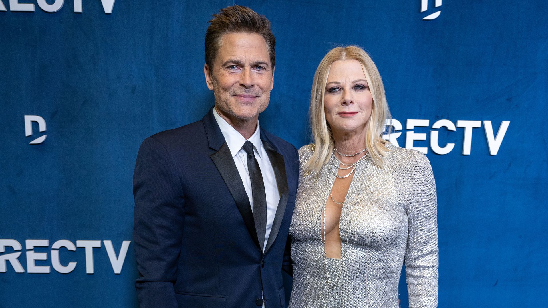 Rob Lowe, 59, looks smitten as he joins wife Sheryl Berkoff, 62, on the red carpet