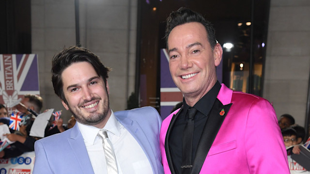 Jonathan Myring in a blue suit and Craig Revel Horwood in a pink suit