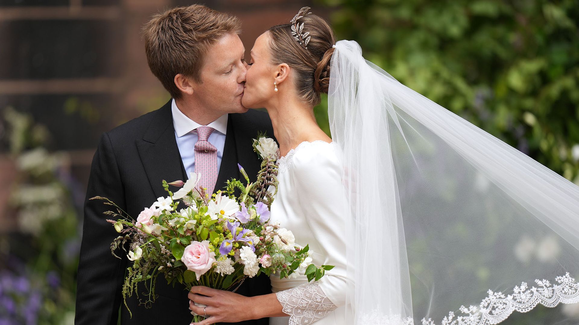 Hugh and Olivia kiss after their wedding