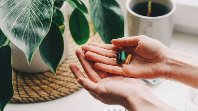 Woman taking vitamins and supplements. Medical concept.