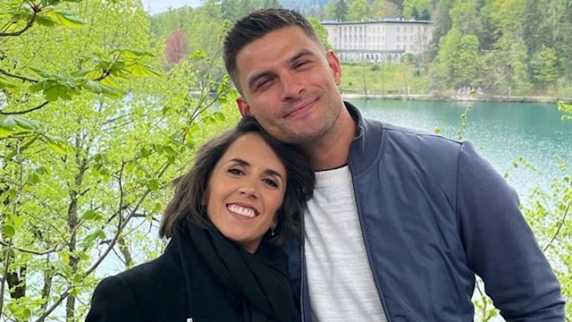 Pregnant Janette Manrara and Aljaz Skorjanek posing for lakeside photo on babymoon