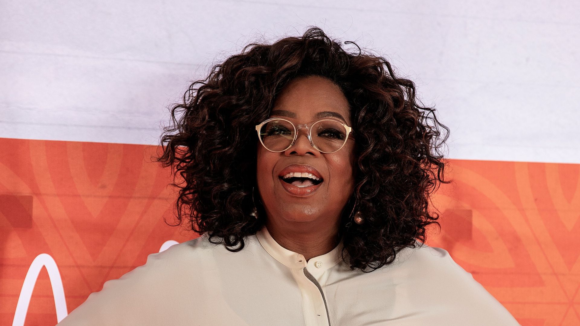 oprah winfrey beige outfit hands on hips