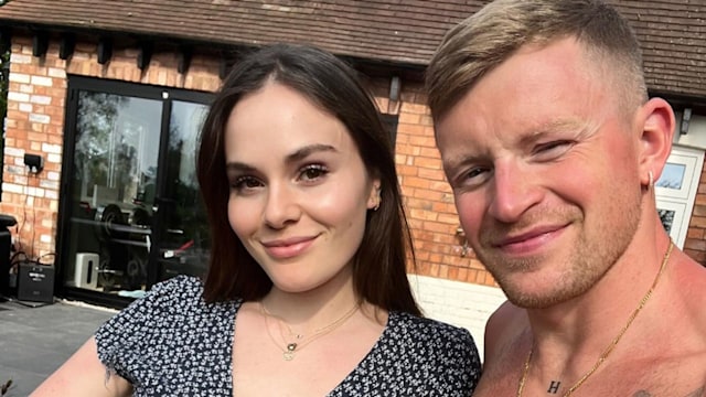 Holly Ramsay in a black dress and a shirtless Adam Peaty in a garden