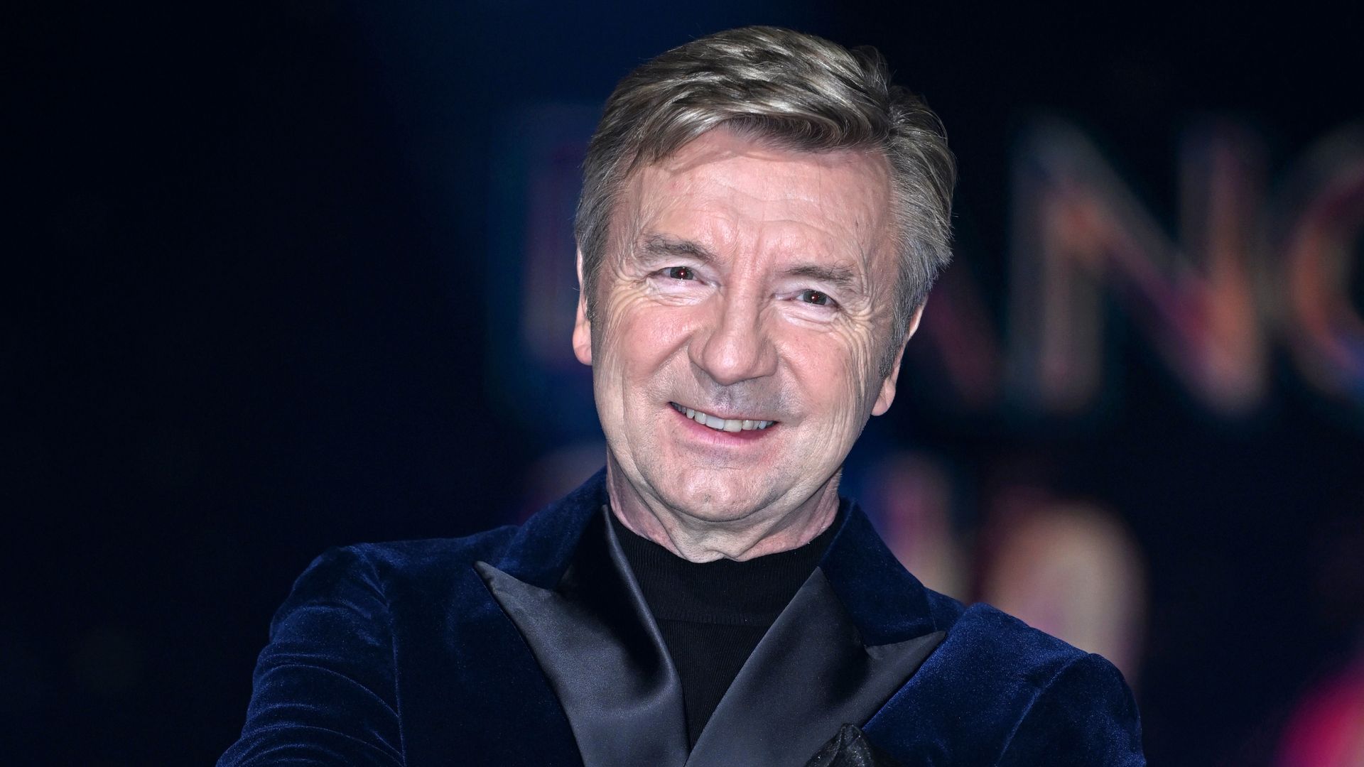 Christopher Dean with his arms crossed