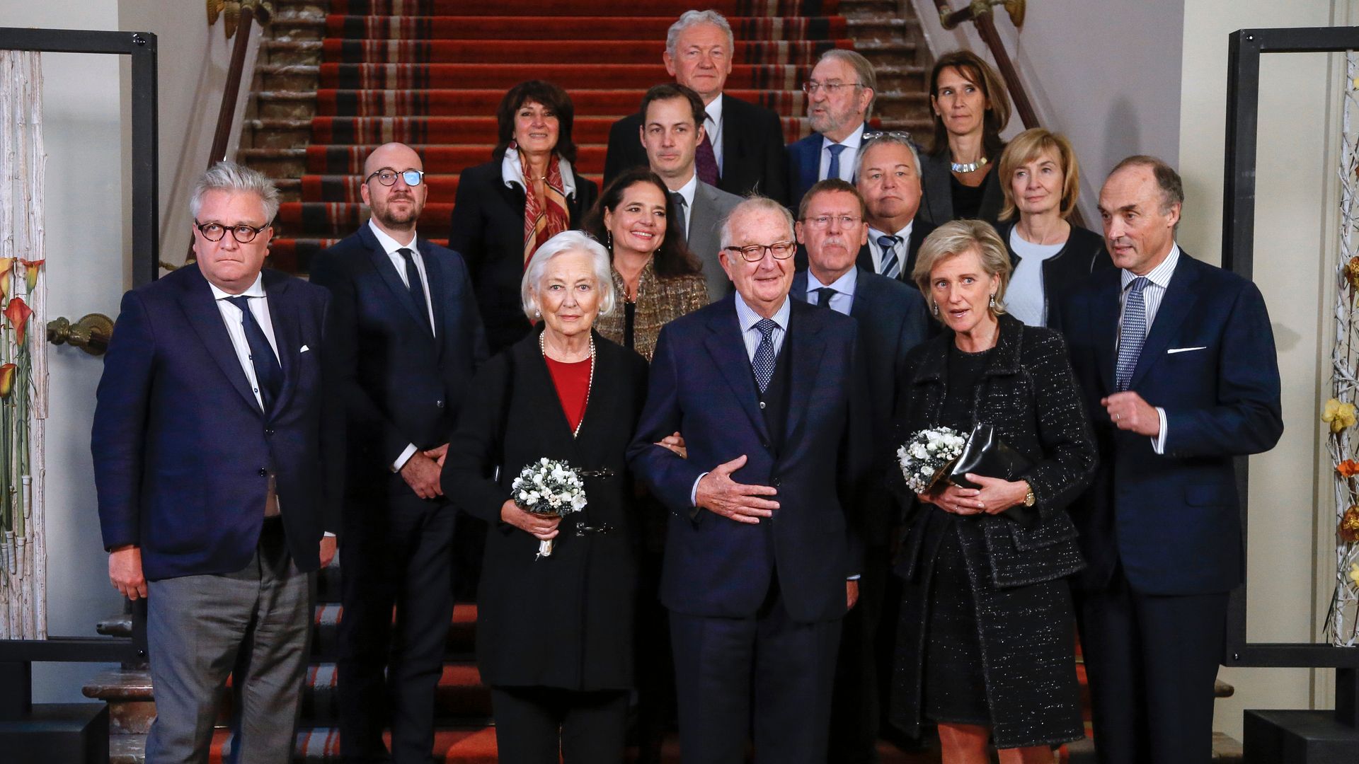 King Albert II stood with Queen Paola, Princess Astrid, Prince Laurent and members of the Belgian government