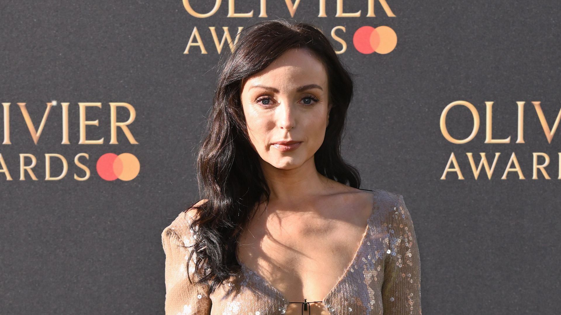 Helen George posing in nude sequin dress at Olivier Awards