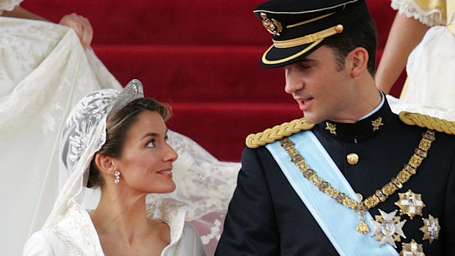 Queen Letizia and her husband King Felipe smile as they leave Madrid's Almudena Cathedral on their wedding day