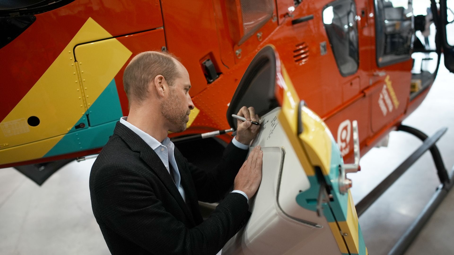 man signing helicopter