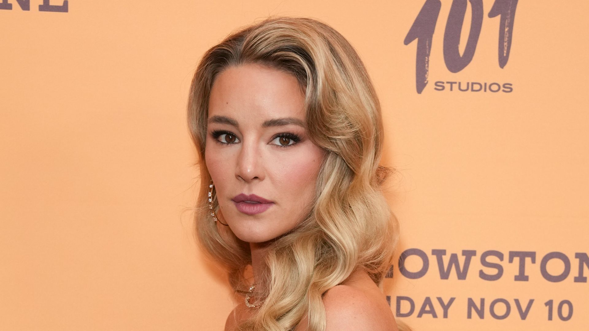 blonde woman in metallic dress posing for photo