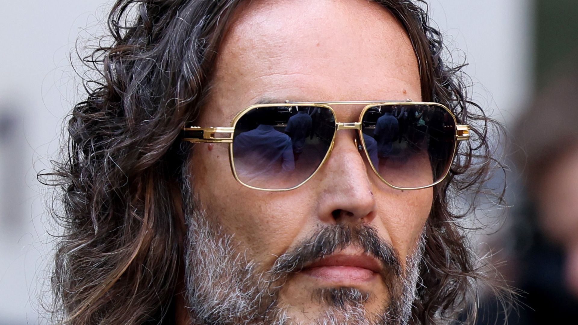 Russell Brand in a pair of sunglasses