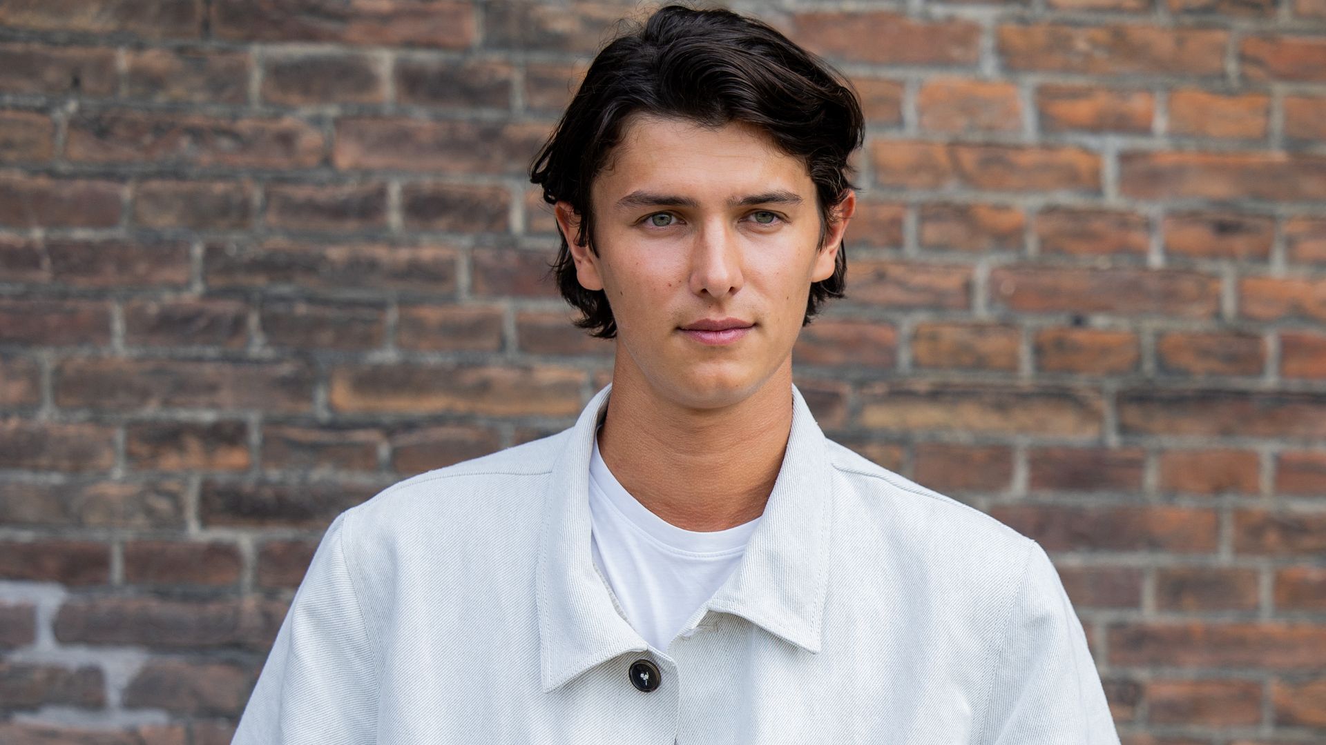 : Count Nikolai of Monpezat wears white jacket, pants outside Mark Kenly Domino Tan during day three of the Copenhagen Fashion Week 