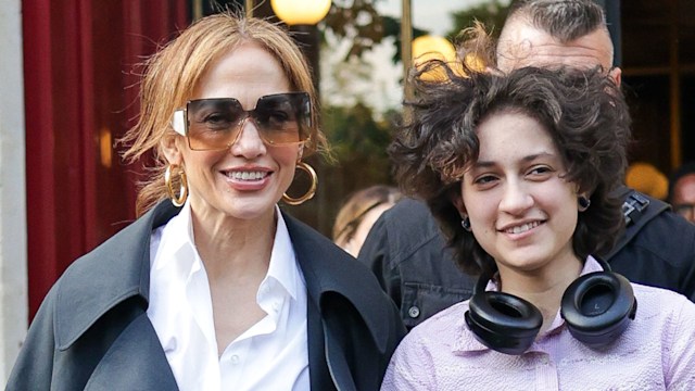Jennifer Lopez and Emme smiling leaving a hotel in Paris, sunglasses and headphones