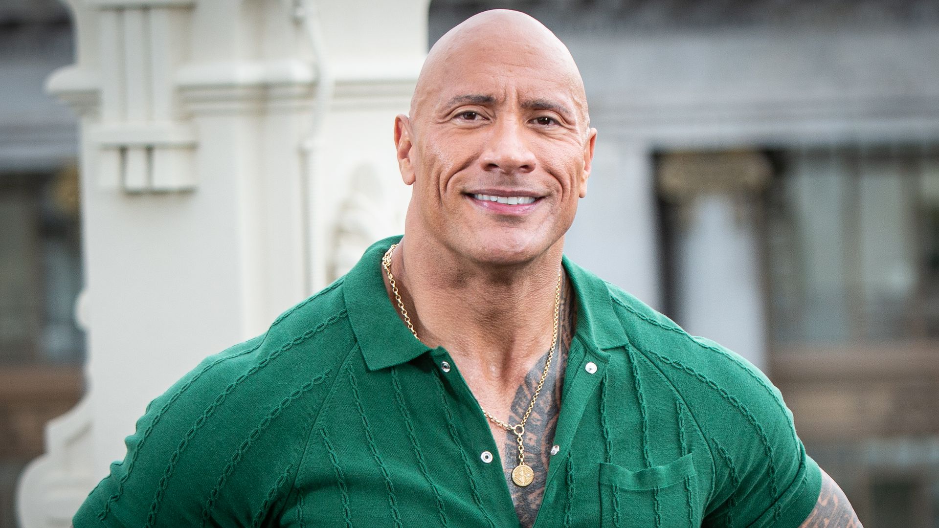 Dwayne shows off tattoos and muscles in tight green t-shirt