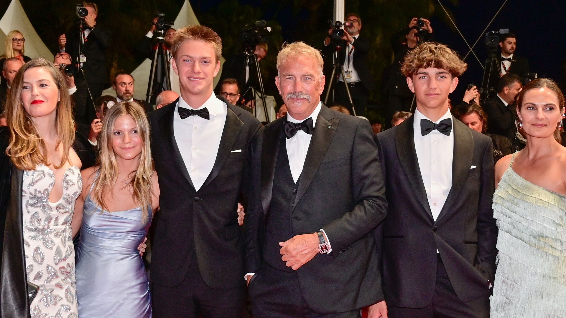 Cayden Wyatt Costner Lily Costner, Hayes Costner, Grace Avery Costner, Kevin Costner and Annie Costner depart the "Horizon: An American Saga" Red Carpet at the 77th annual Cannes Film Festival at Palais des Festivals on May 19, 2024 in Cannes, France.