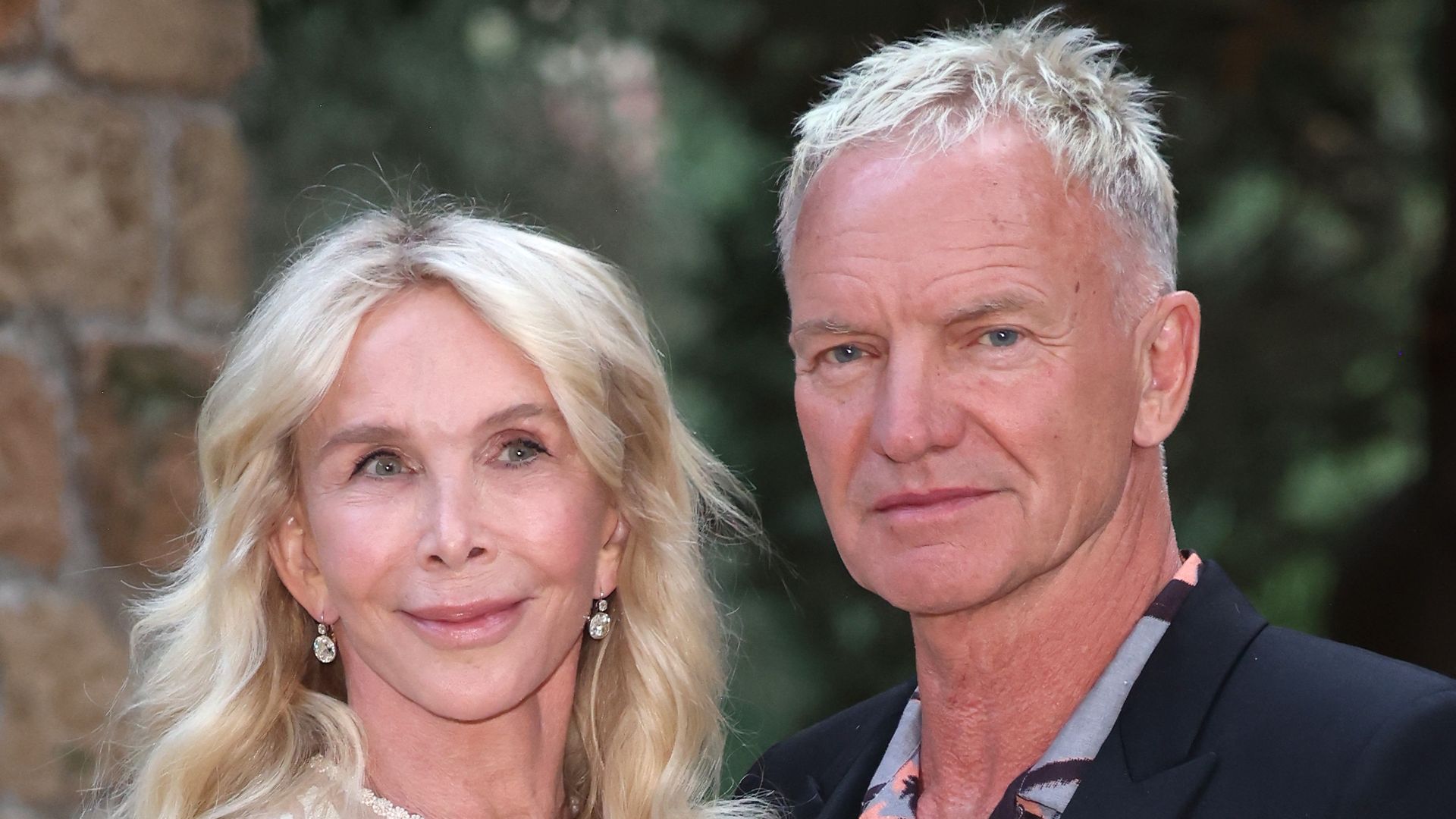 Trudie Styler in white dress and Sting posed outside in rome