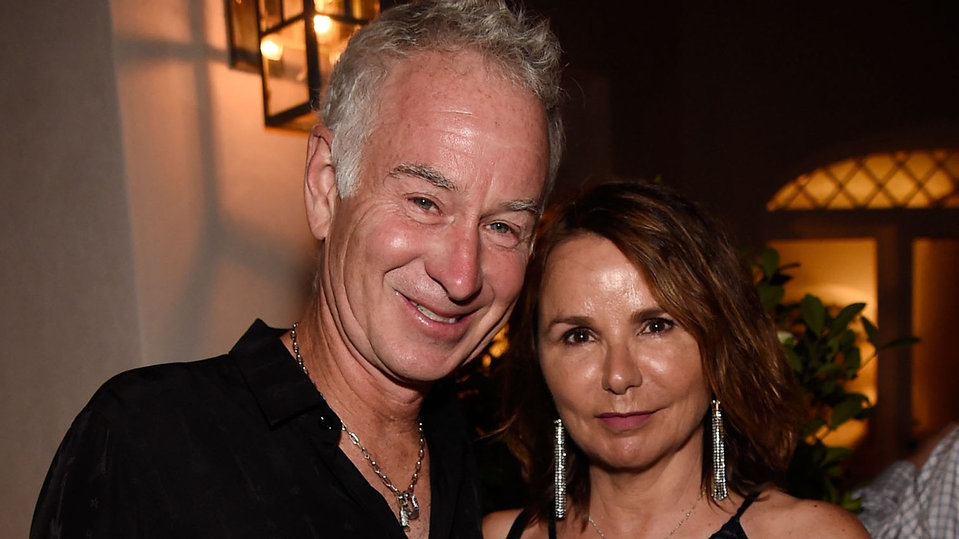 John McEnroe and Patty Smyth in matching black outfits