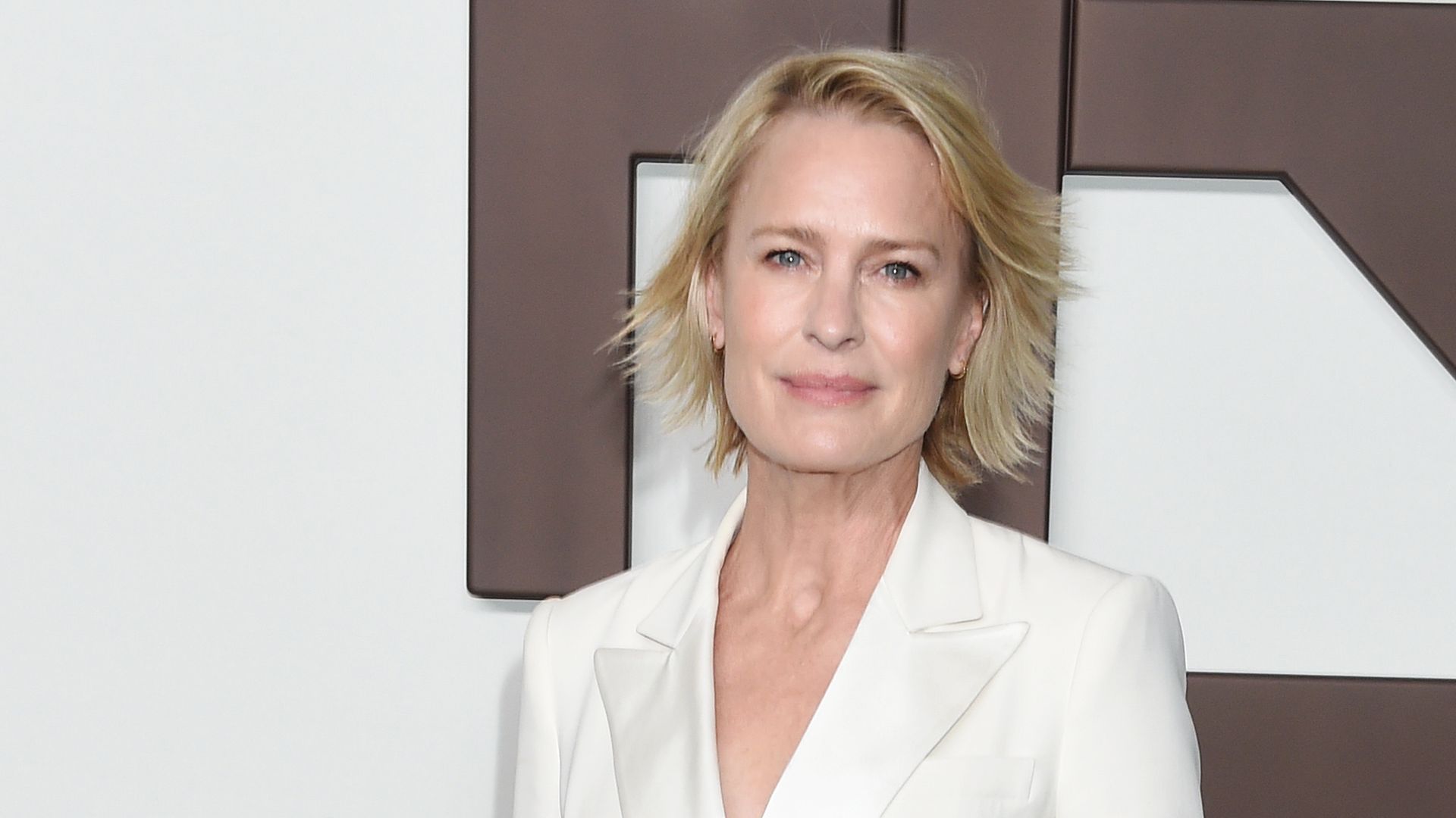 Robin Wright looks as ethereal as ever in a plunging fitted white floor-length dress from rare high-profile outing