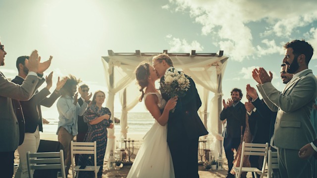 Beautiful Bride and Groom Celebrate Wedding Outdoors on a Beach