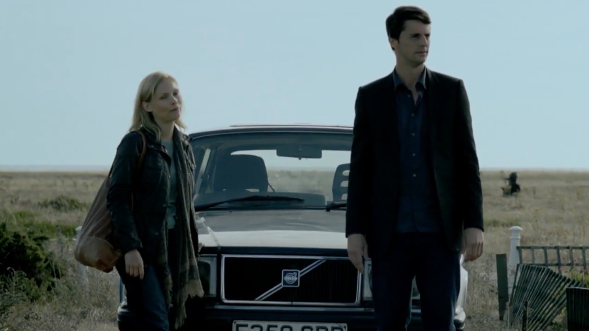 woman and man standing in front of a car