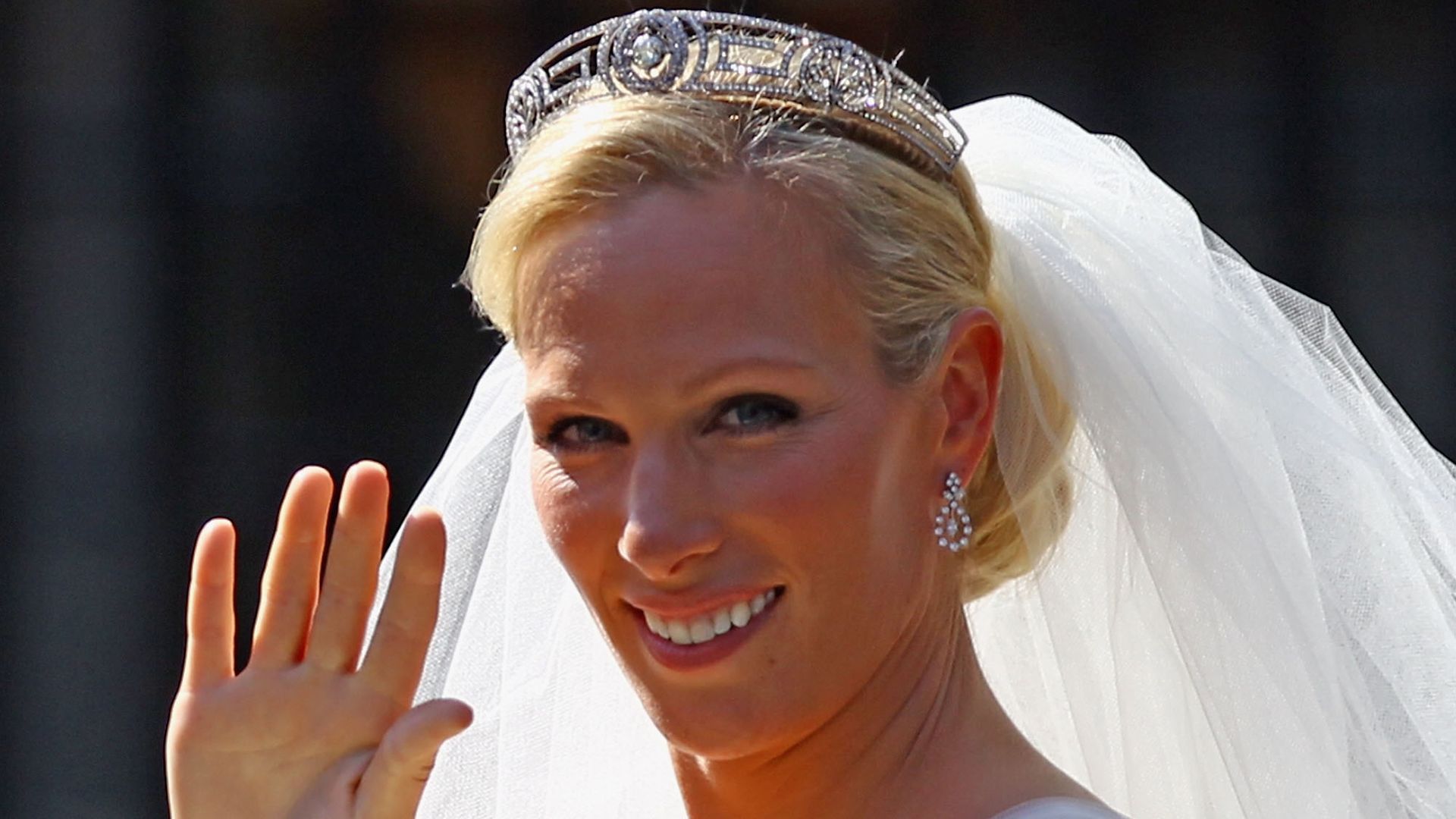 Zara Phillips waving to crowds at her royal wedding with Mike Tindall 