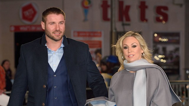 Ben Cohen and Kristina Rihanoff walking on a blue carpet