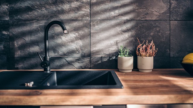 A clean black kitchen sink