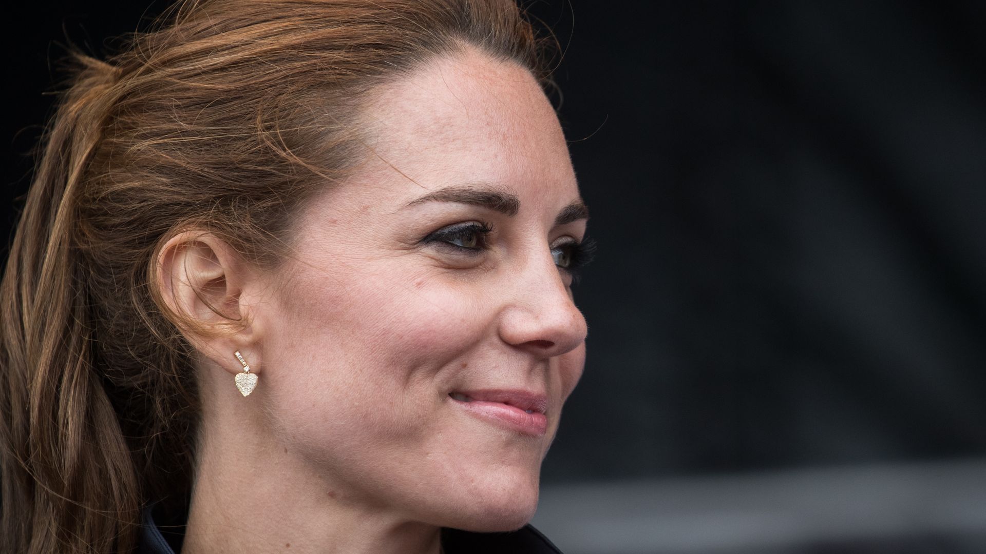Princess Kate smiling in heart earrings