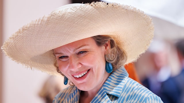 Queen Mathilde in a large sunhat