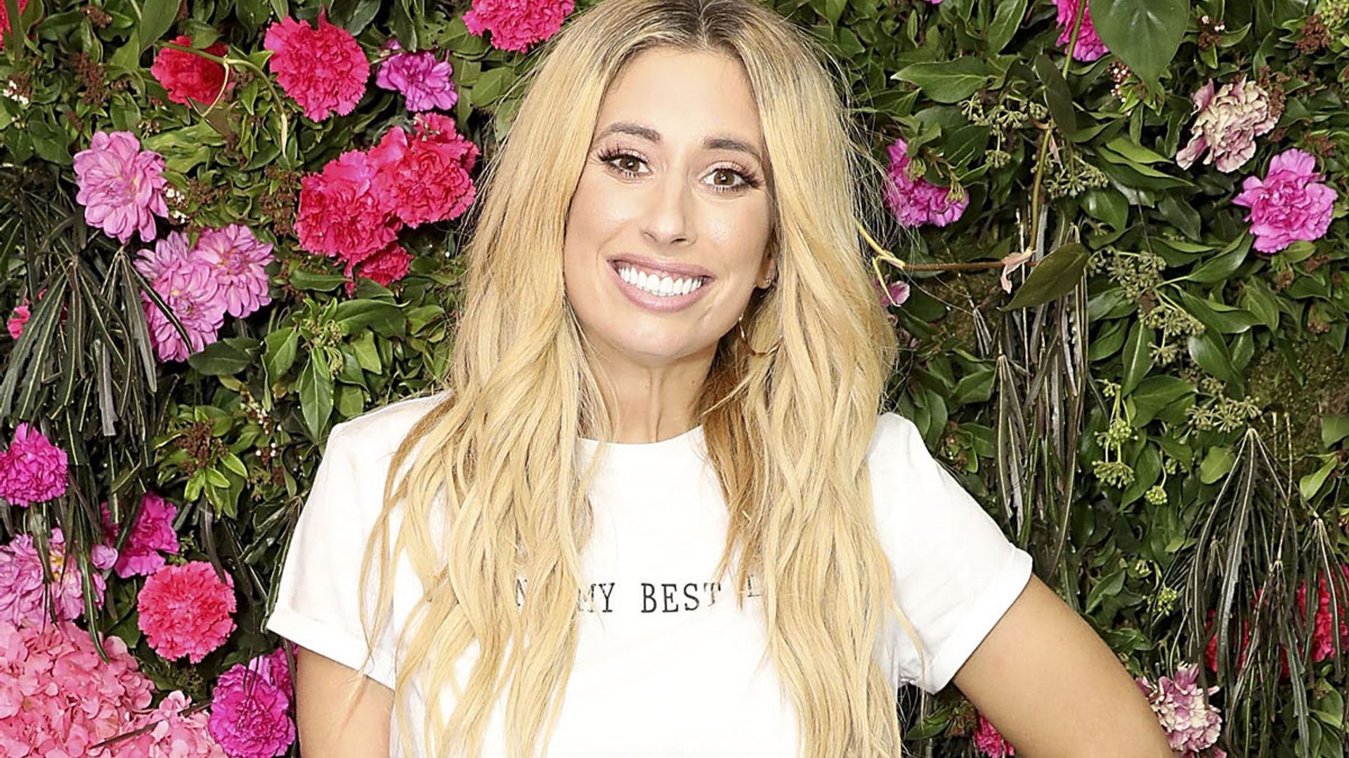 stacey solomon smiling against flowers