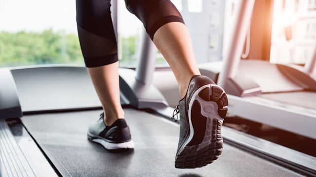 Woman running exercise on track treadmill