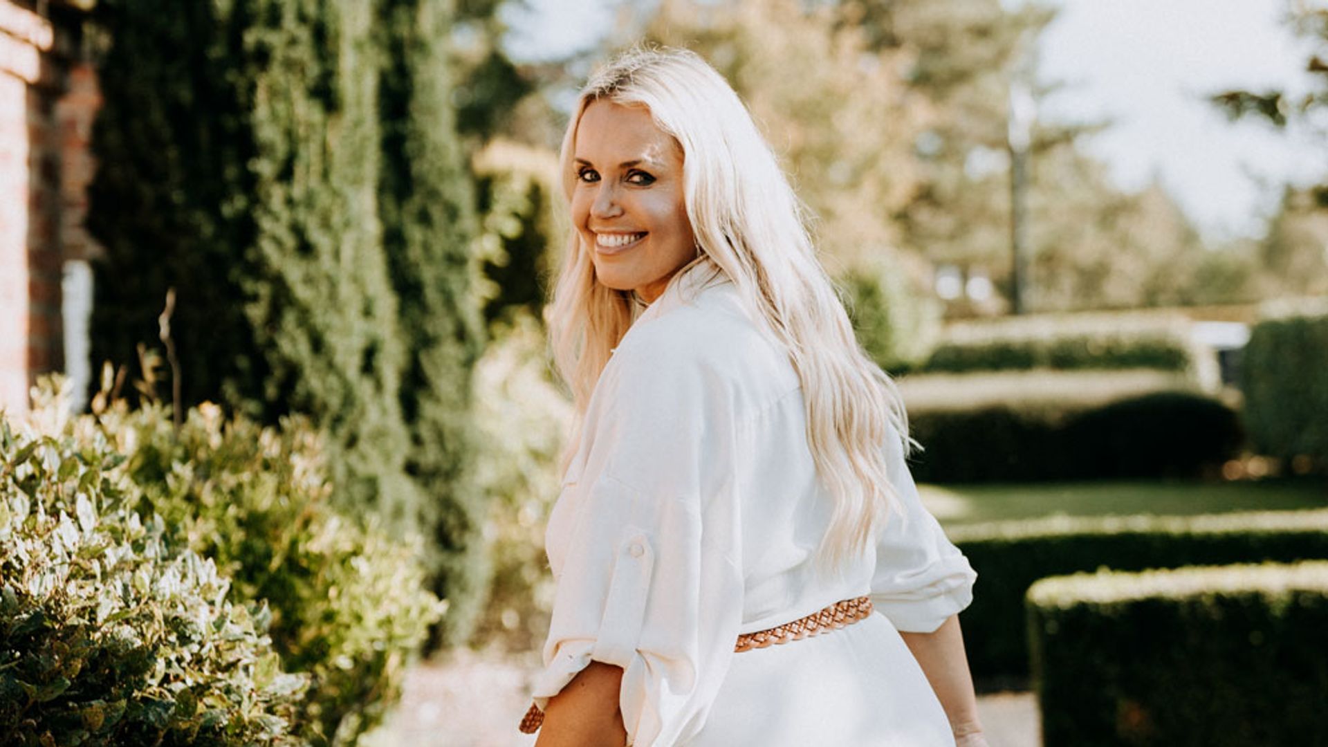 woman dressed in white looking over her shoulder