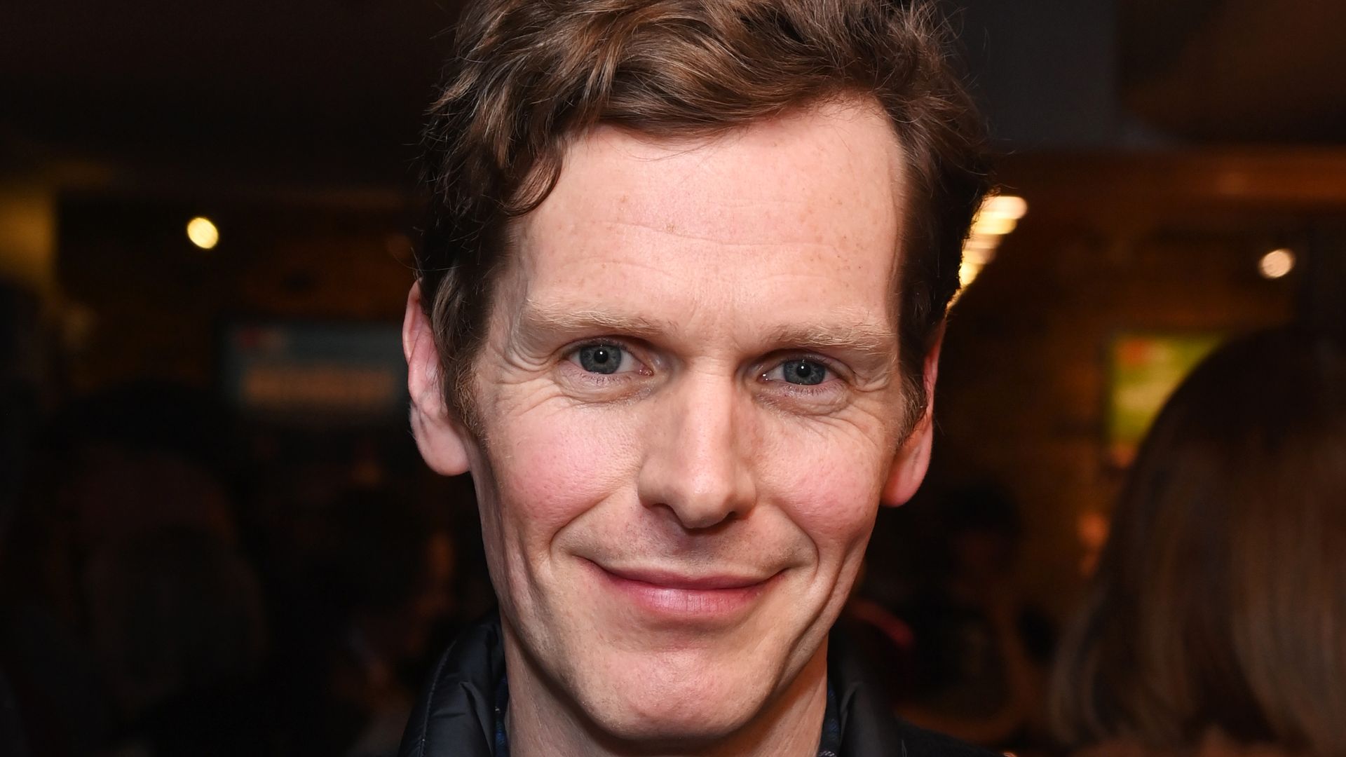 close-up of actor smiling for photo