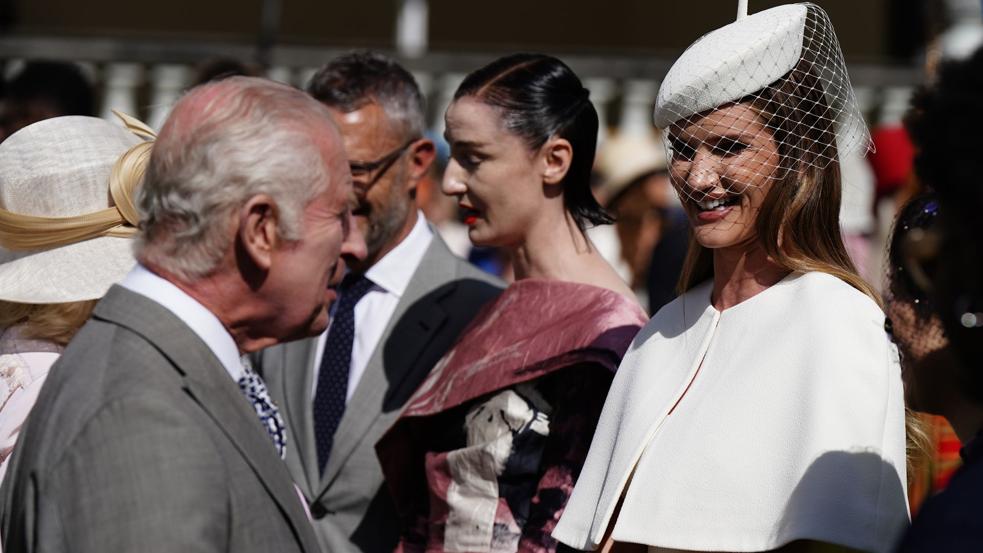 King Charles III speaks with Rosie Huntington-Whiteley