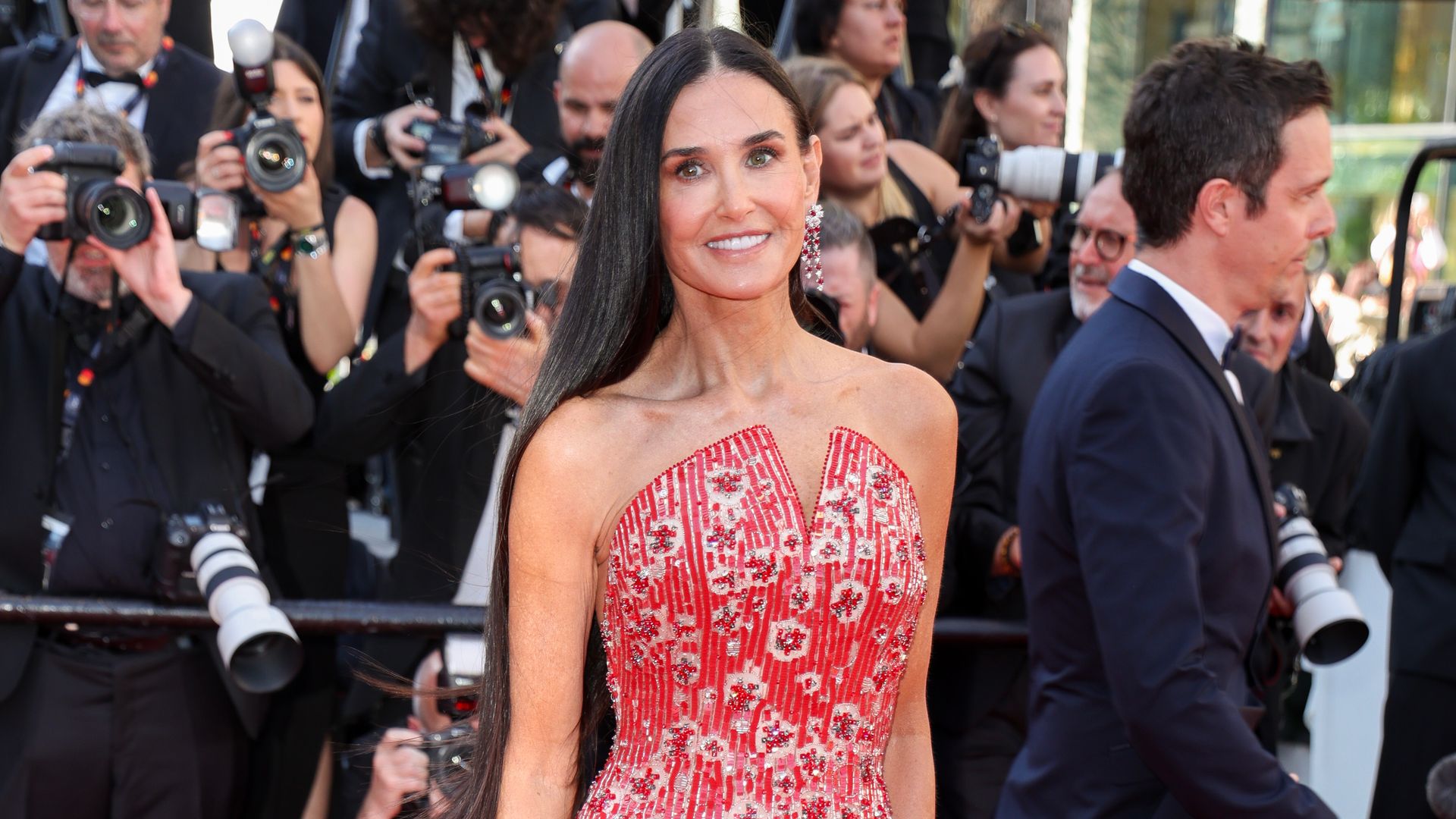 Demi Moore in a red dress on a red carpet